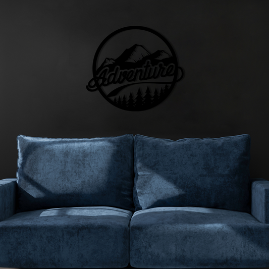 The design is set within a circular frame, featuring majestic mountains above a lush forest, with the word ADVENTURE boldly displayed across the center. Acrylic glass decor - Vibewall