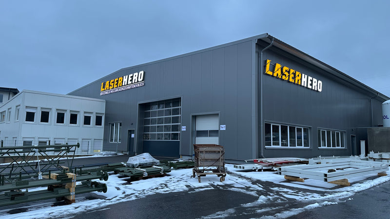 Factory building with 'LaserHero' branding on both sides.