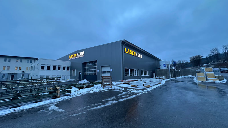 Factory building with 'Lasertherm' branding on both sides.