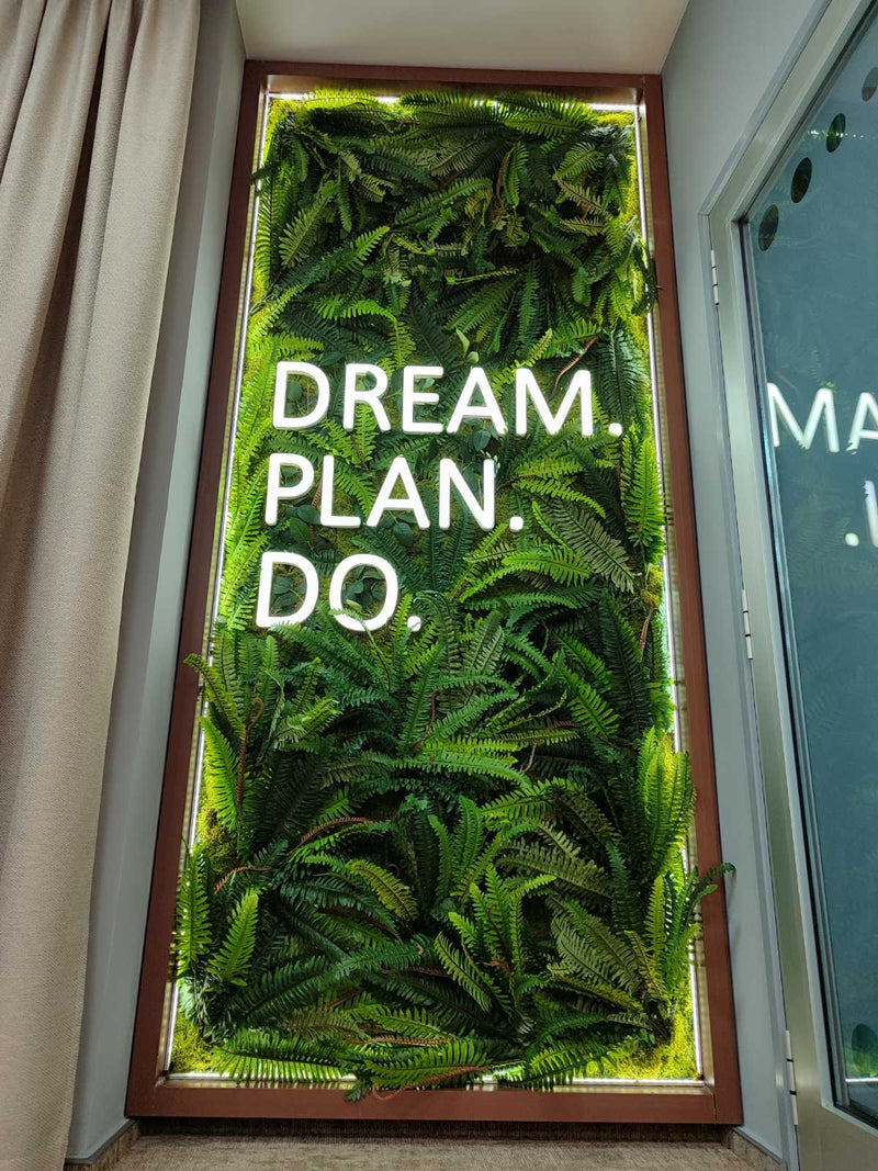Vertical garden wall with motivational quote 'Dream. Plan. Do.'