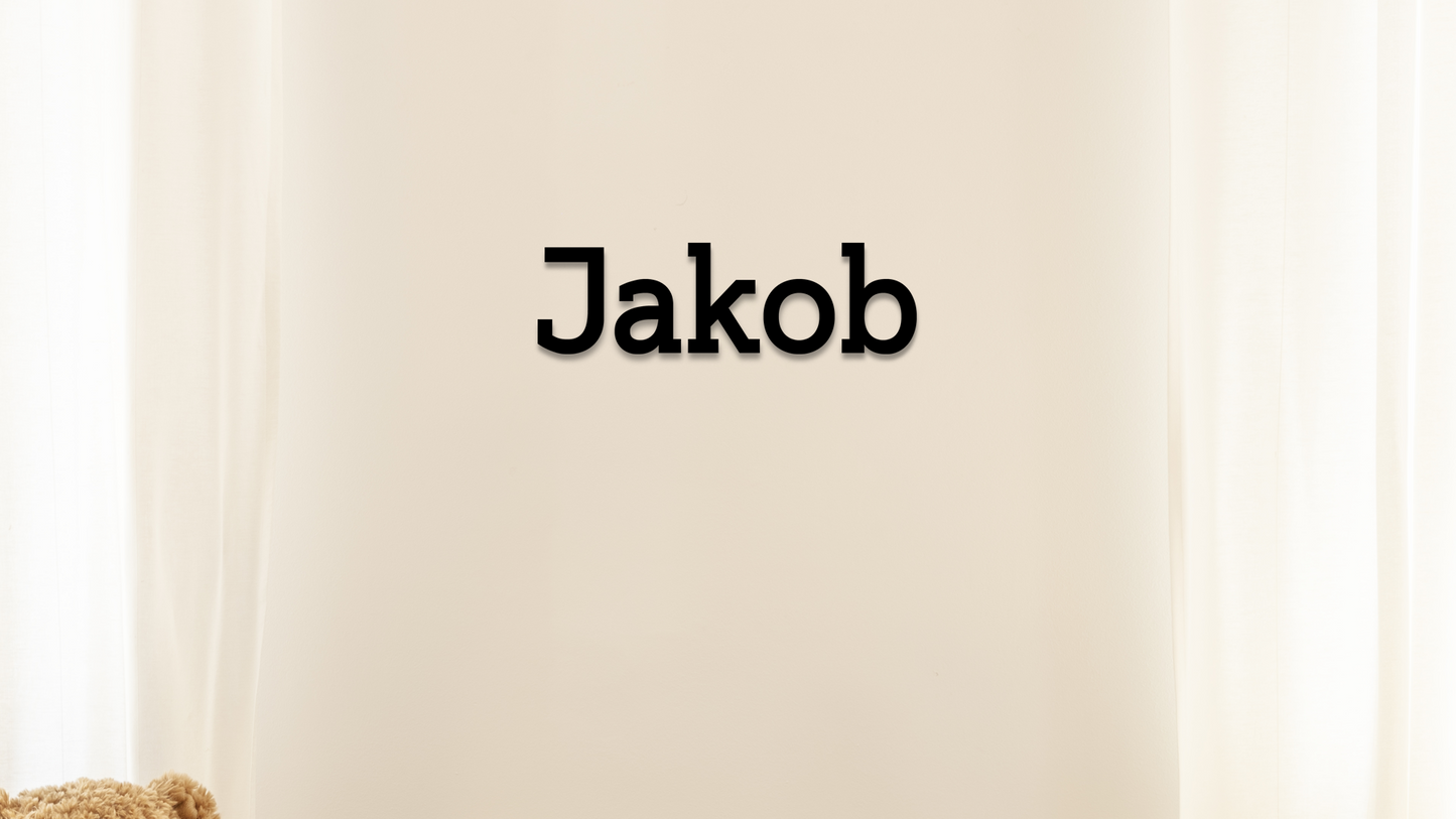Name 'Jakob' printed in black on a beige background - Acrylic wall dekor - Vibewall