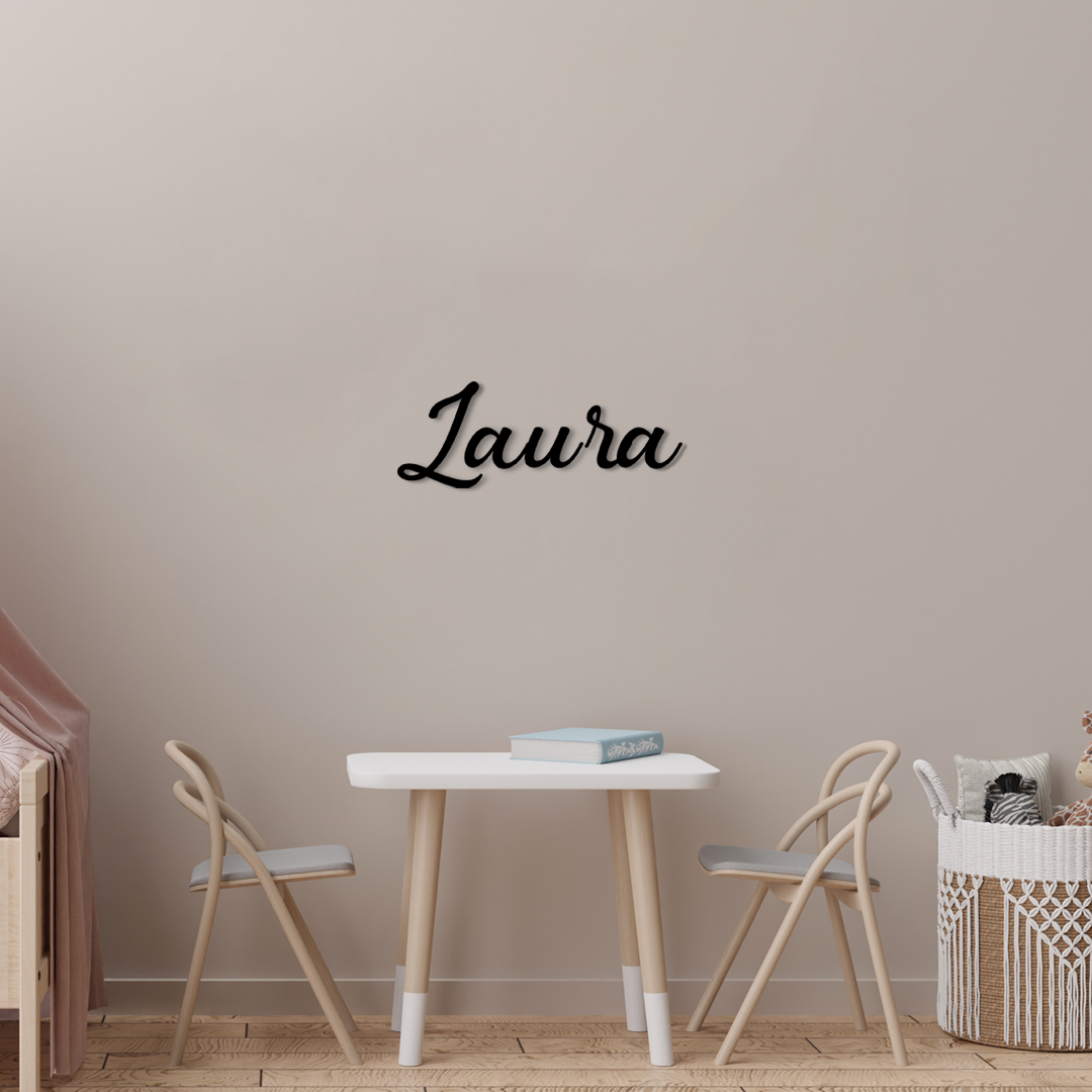 Wooden name sign 'Laura' on a wall above a small table and chairs. Acrylic wall dekor - Vibewall