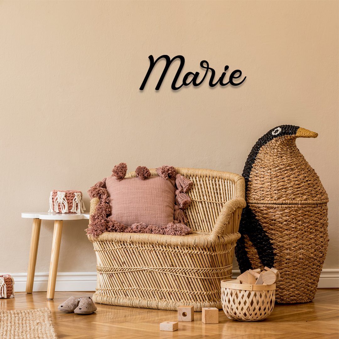 Wicker chair with pink cushion and decorative pillows in a room with a wicker basket and decorative penguin. Acrylic wall decor - Vibewall