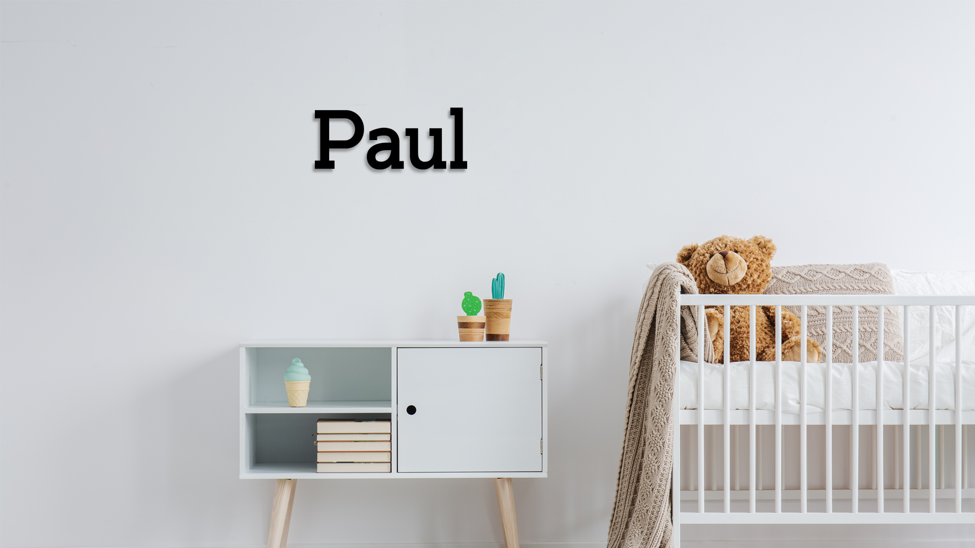 Nursery room with a crib, cabinet, and decorative items on a white wall. Acrylic wall decor - Vibewall