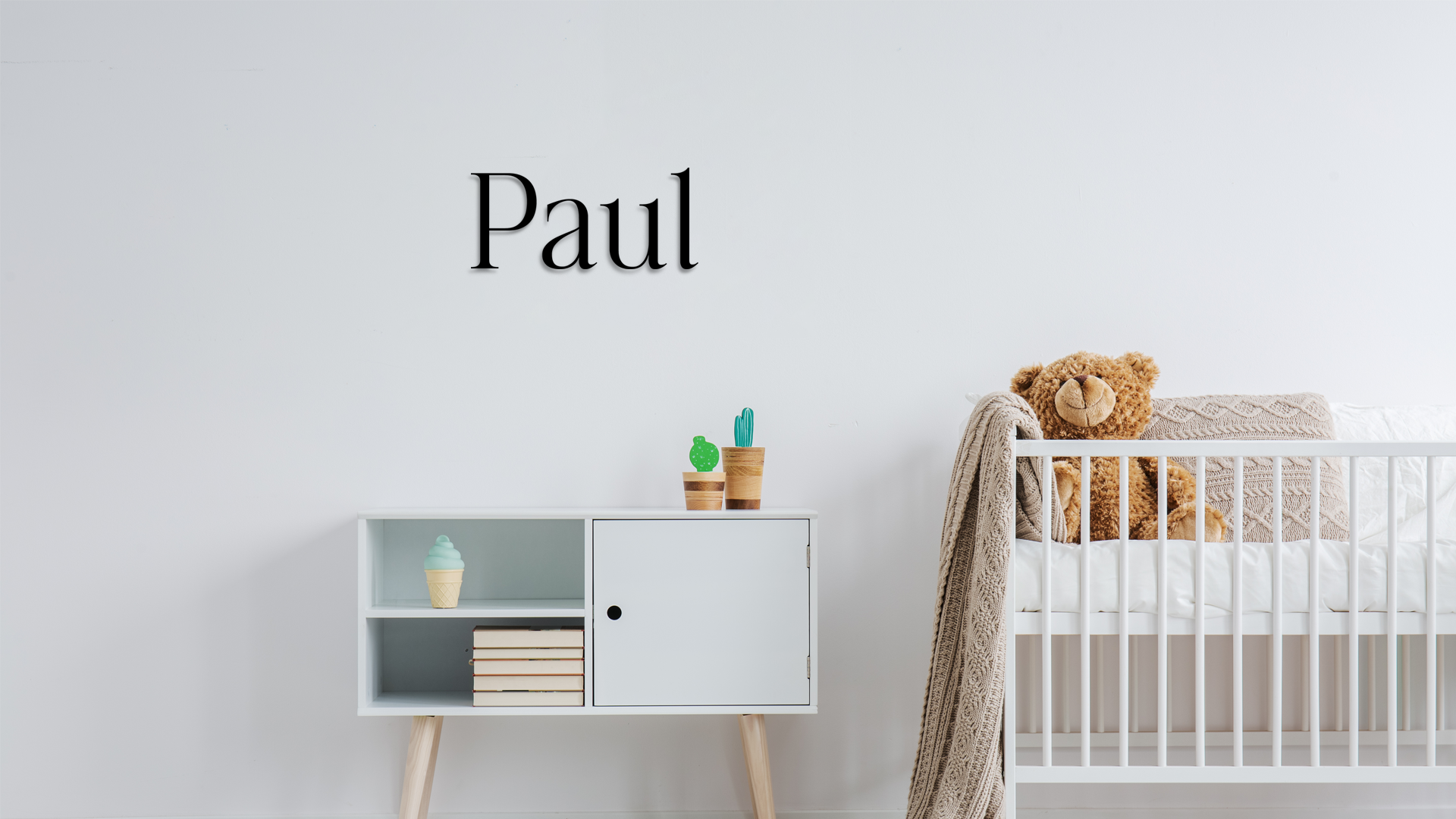Nursery room with a crib, side table, and decor items on a light gray background. Acrylic wall dekor - Vibewall