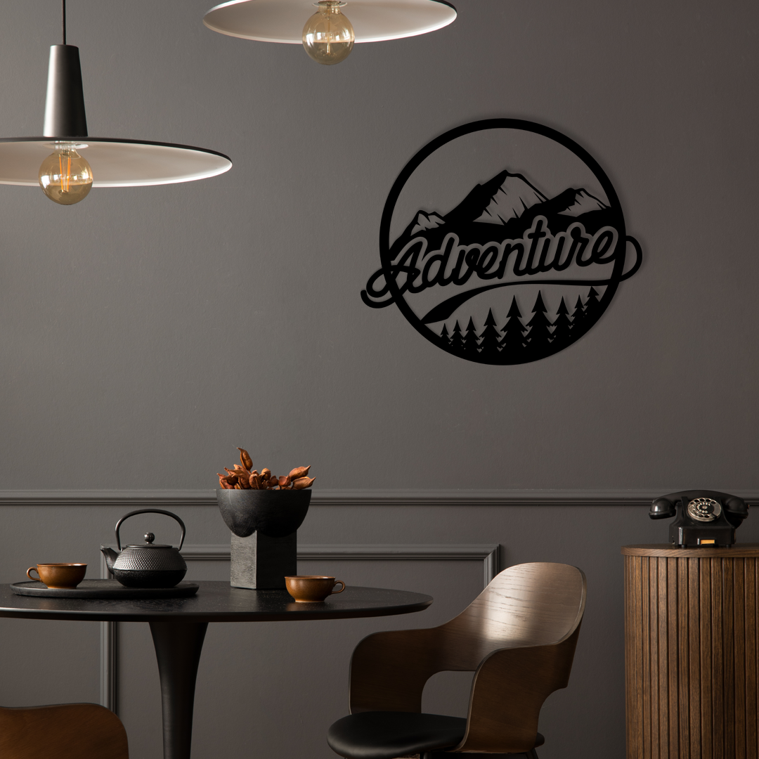 The design is set within a circular frame, featuring majestic mountains above a lush forest, with the word ADVENTURE boldly displayed across the center. Acrylic glass decor - Vibewall