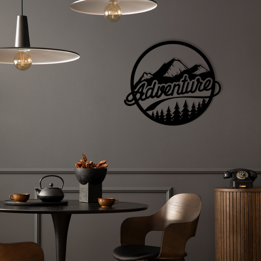 The design is set within a circular frame, featuring majestic mountains above a lush forest, with the word ADVENTURE boldly displayed across the center. Acrylic glass decor - Vibewall