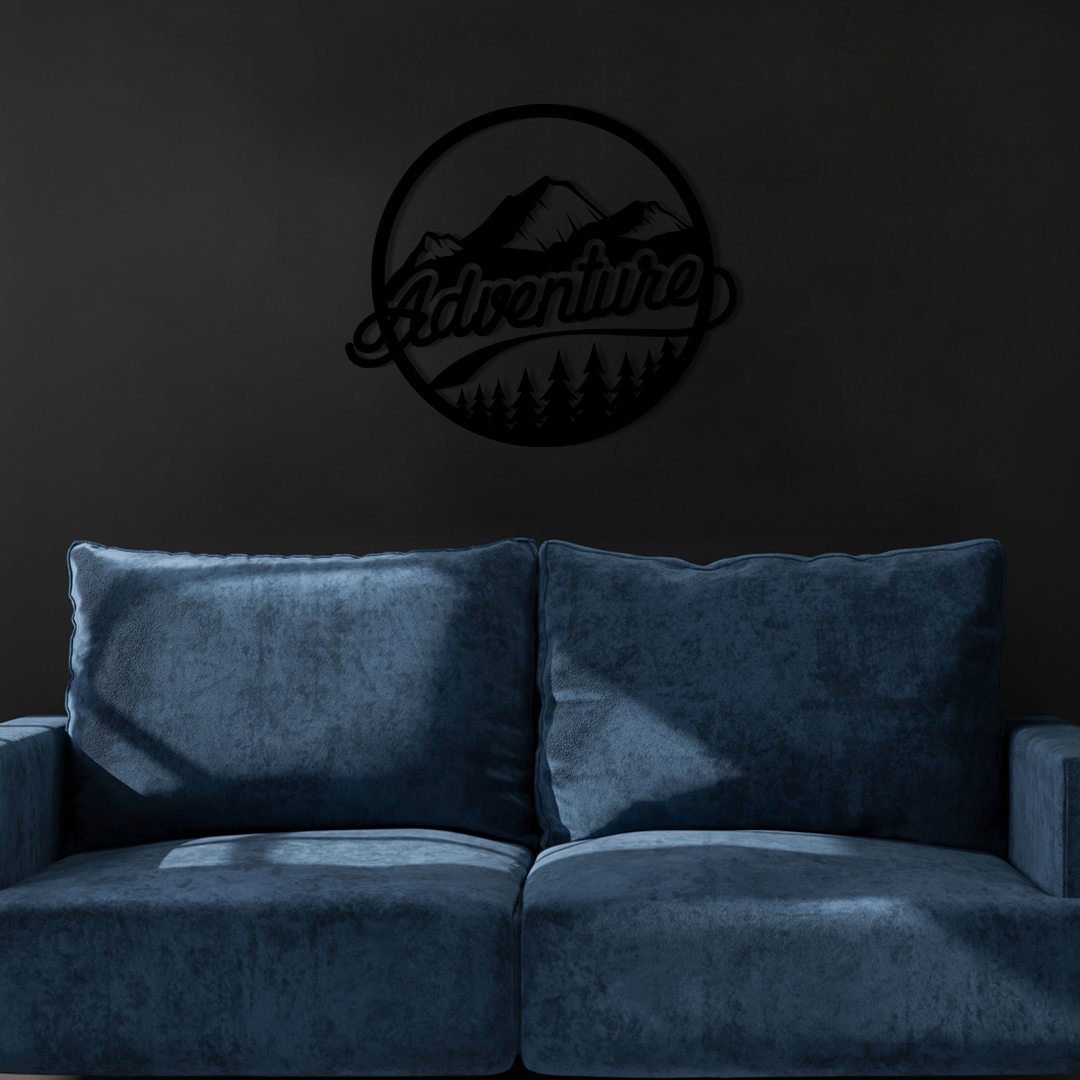 The design is set within a circular frame, featuring majestic mountains above a lush forest, with the word ADVENTURE boldly displayed across the center. Acrylic glass decor - Vibewall