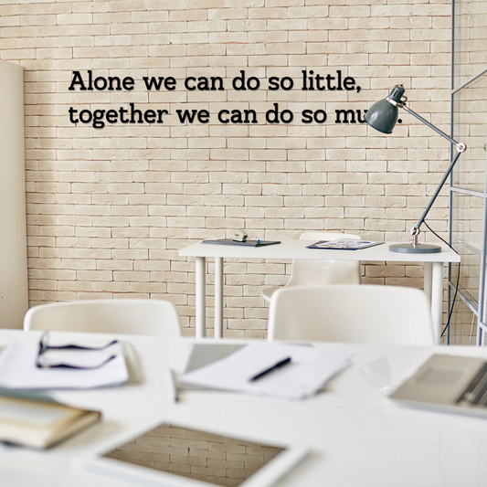 Office setting with a motivational quote on the wall, featuring a desk and chairs. Arcylic wall decor - Vibewall