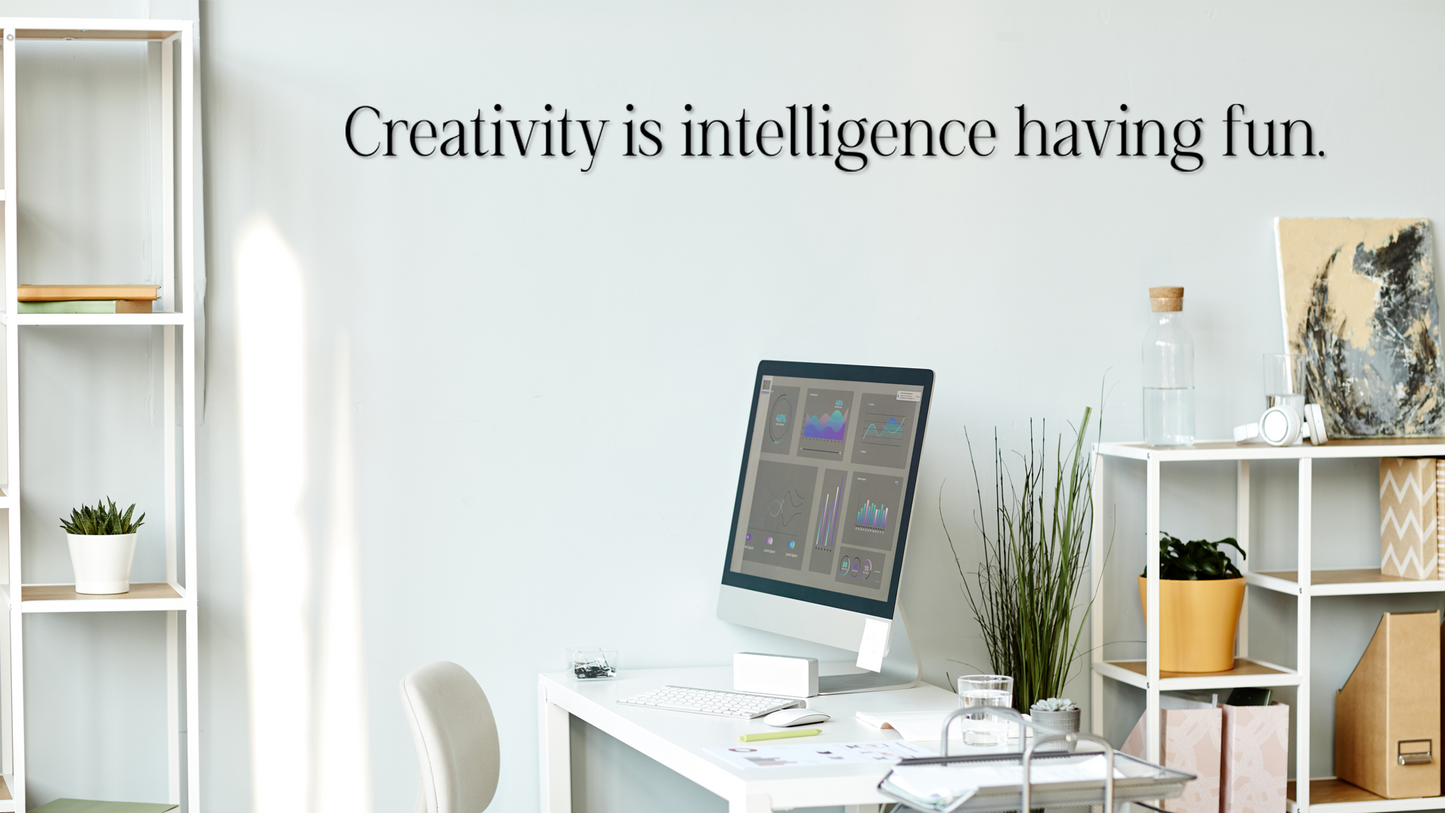 Modern office space with a computer monitor on a desk, shelves with decor, and a quote about creativity. Acrylic wall decor - Vibewall
