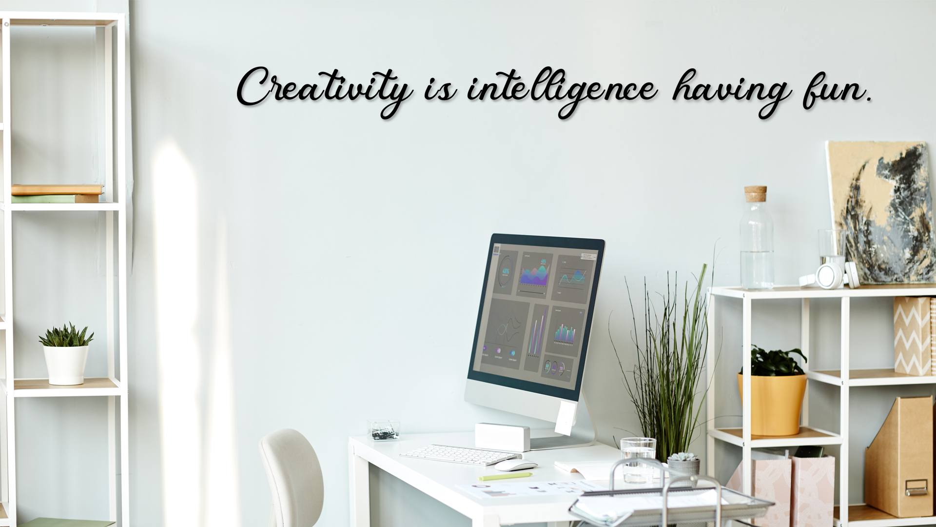 Modern office space with a computer monitor, desk, and shelves with decor items. Acrylic wall decor - Vibewall