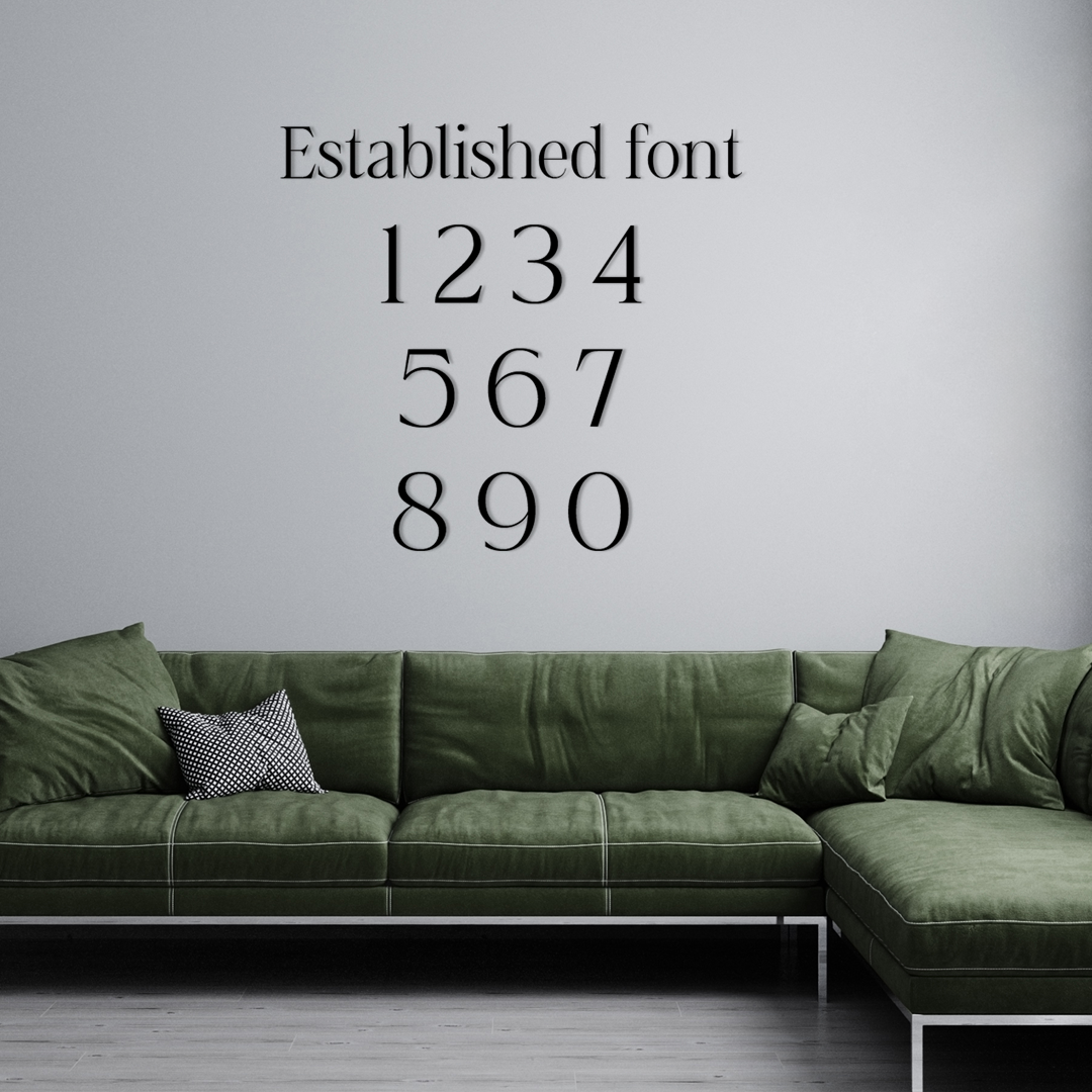 Green sectional sofa with decorative pillows against a gray wall featuring 'Established font' text. Acrylic wall decor - Vibewall