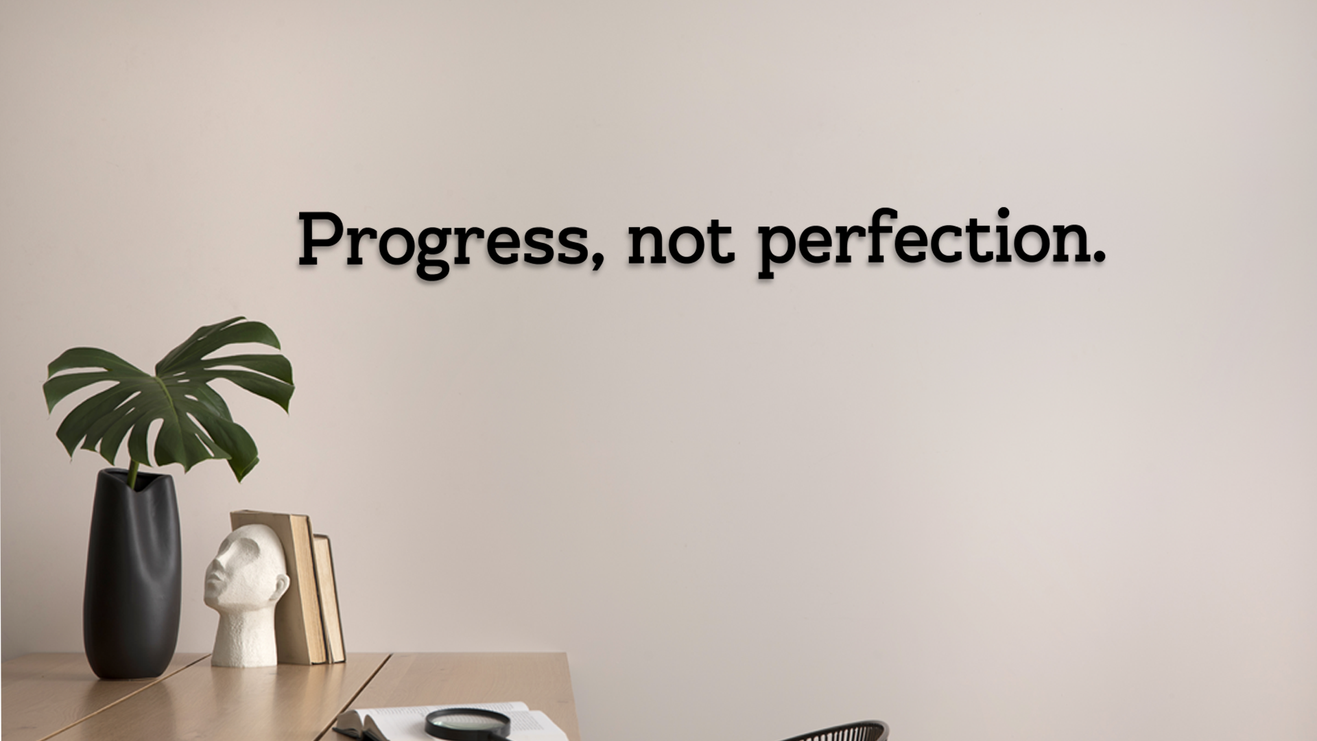 Motivational quote 'Progress, not perfection.' on a wall with minimal decor. Acrylic wall decor - Vibewall