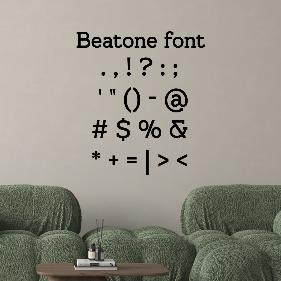 Text in Beatone font on a beige wall with green sofas and a small table. Acrylic wall decor - Vibewall