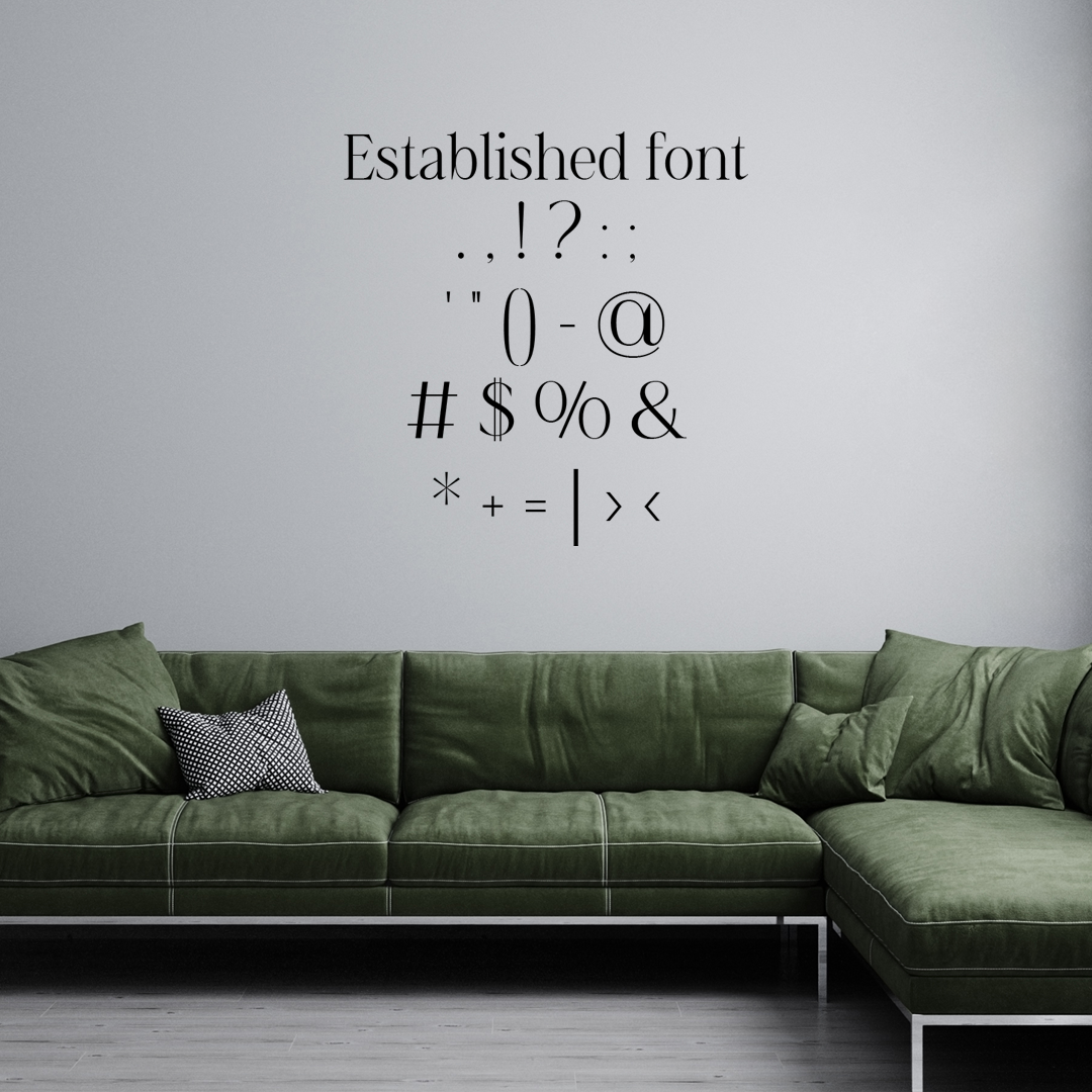 Green sectional sofa with decorative pillows against a gray wall featuring a list of punctuation marks. Acrylic wall decor - Vibewall