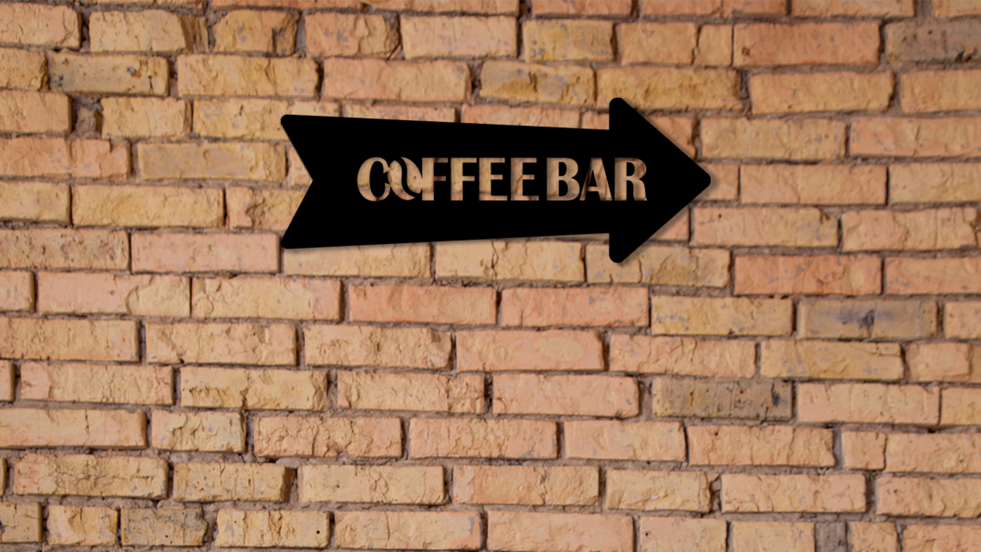 Black arrow sign pointing to a coffee bar on a brick wall. Acrylic wall decor - Vibewall