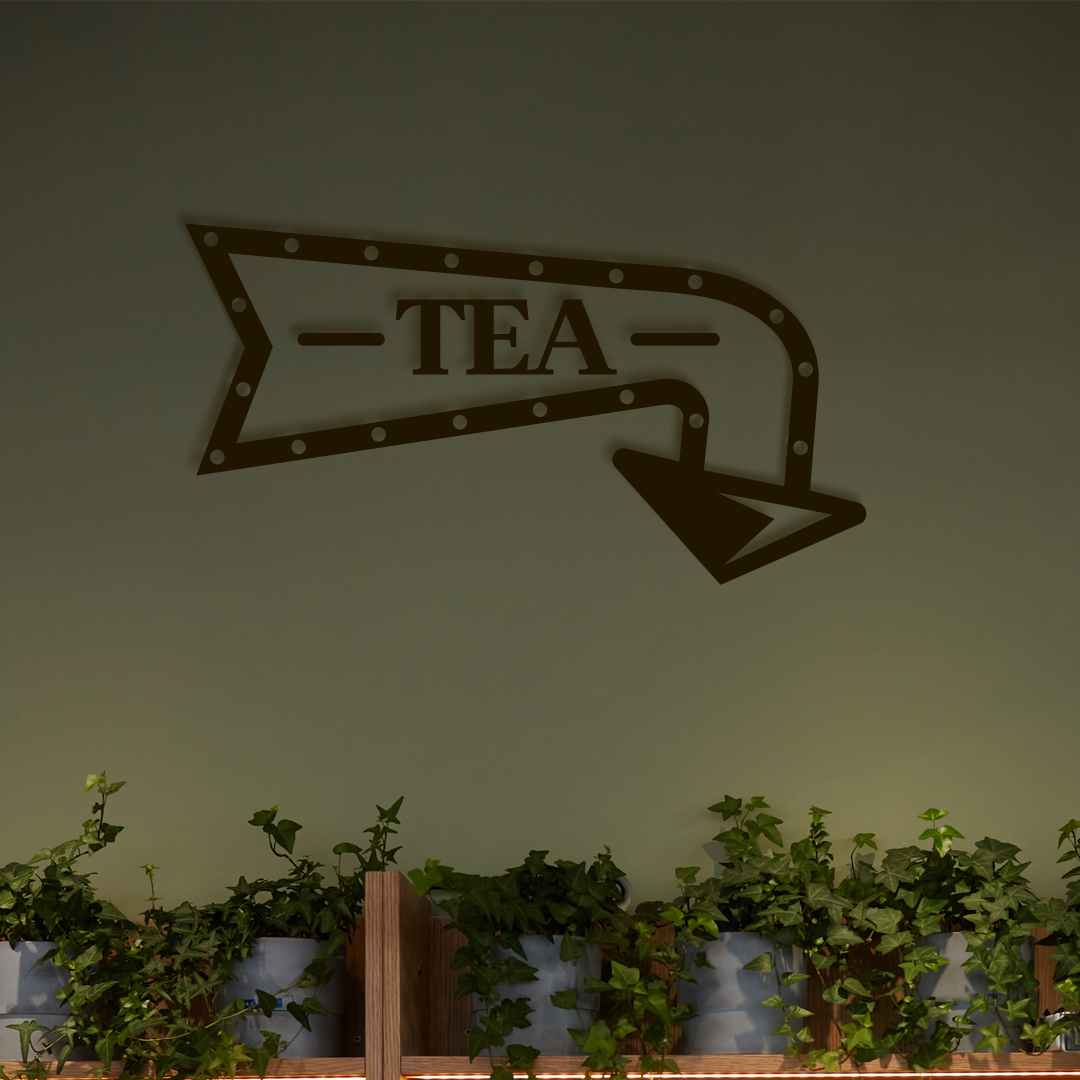 Decorative wall sign with 'TEA' on an arrow, above a row of potted plants. Acrylic wall decor - Vibewall