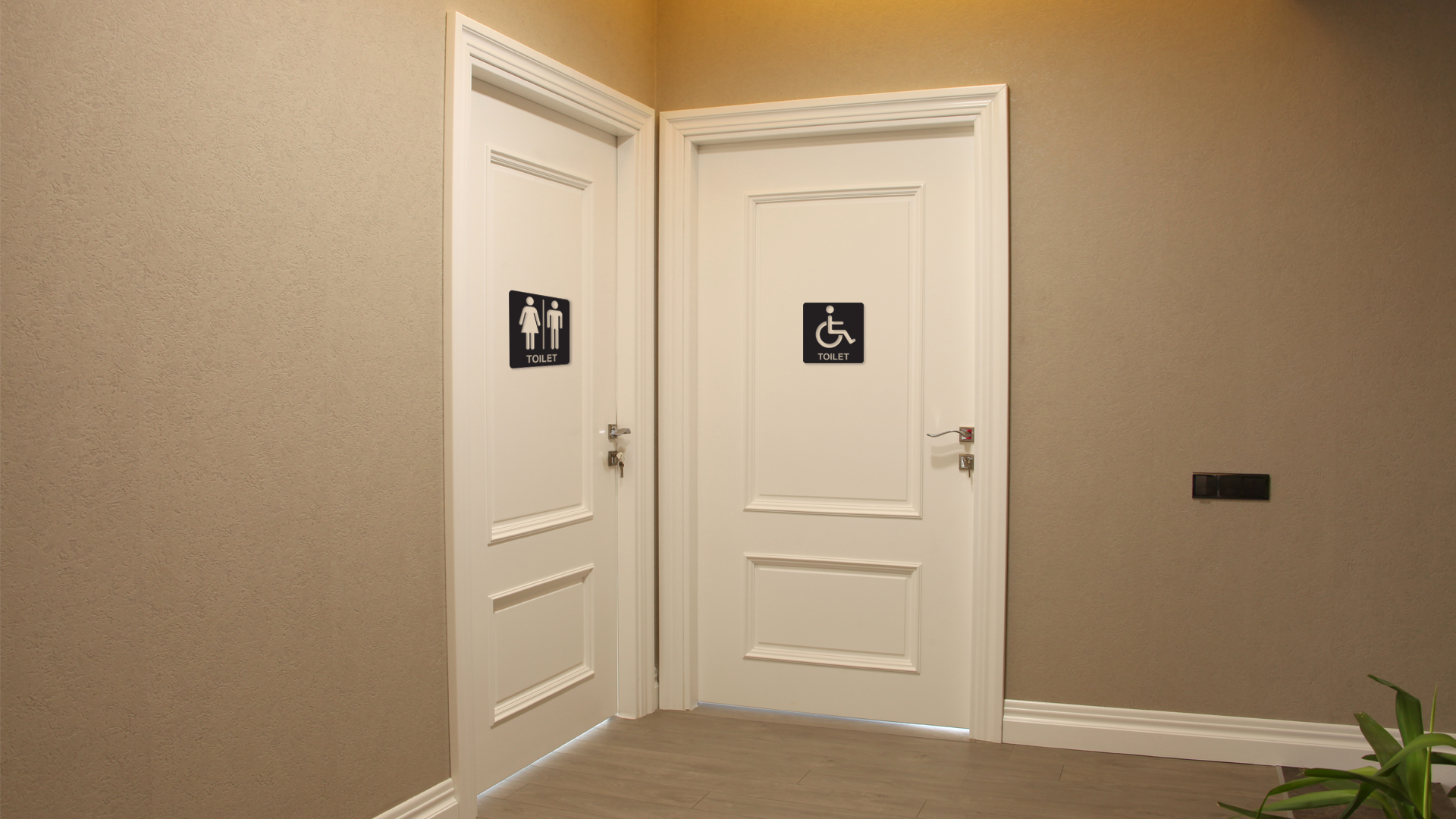 Two white doors with accessibility signs on a beige wall. Acrylic wall decor - Vibewall
